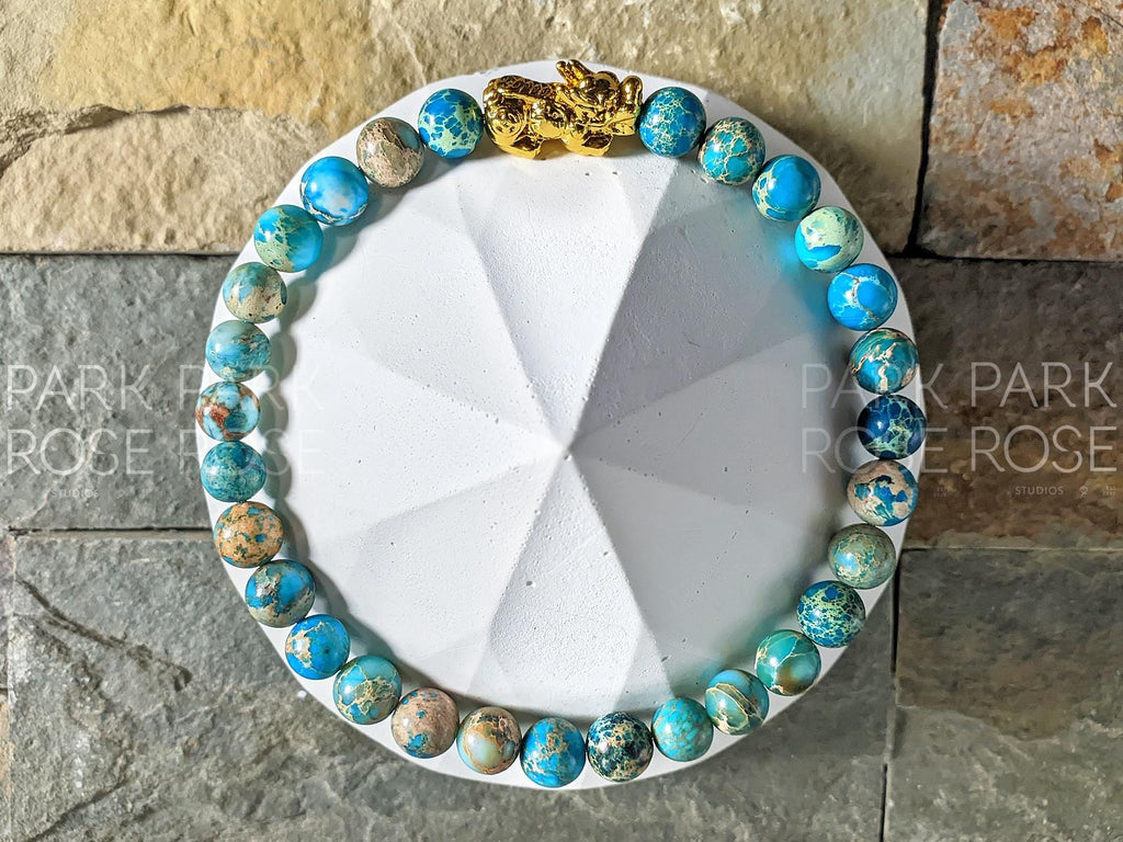 Lake Blue Jasper Bracelet: 24K Gold Plated Pixiu Charm